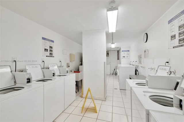 3161 S Ocean Dr Unit 203, Hallandale Beach, FL 33009 - shared laundry featuring washer and clothes dryer and light tile patterned flooring