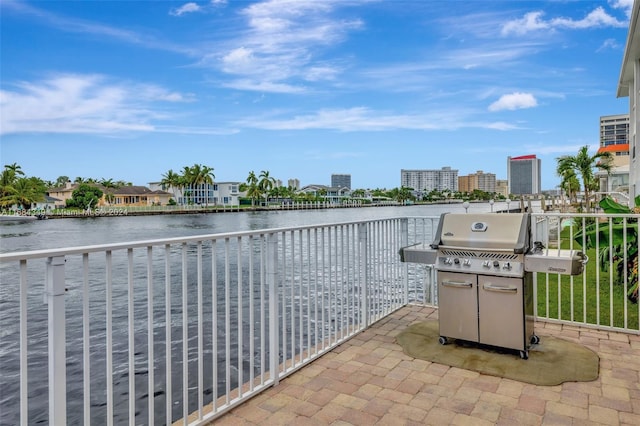 view of patio / terrace with a grill and a water view