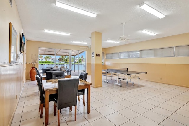 dining room with light tile patterned flooring, a textured ceiling, and ceiling fan