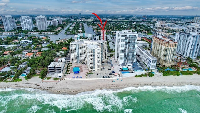 bird's eye view featuring a water view and a beach view