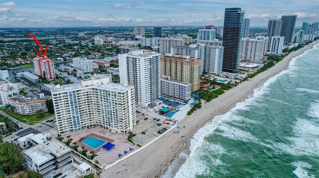 drone / aerial view with a water view and a beach view