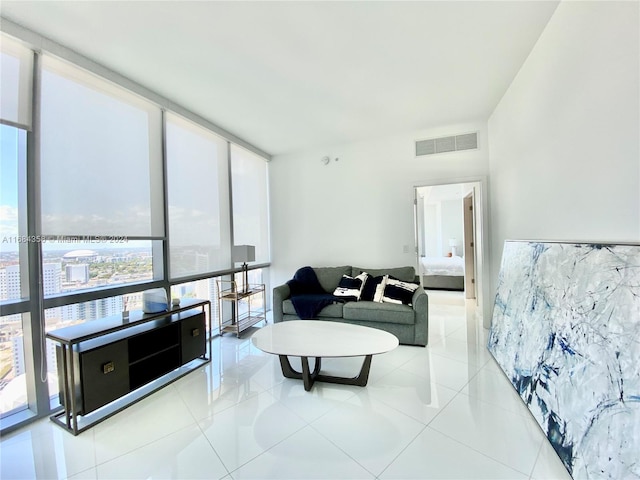 living room with expansive windows and light tile patterned floors