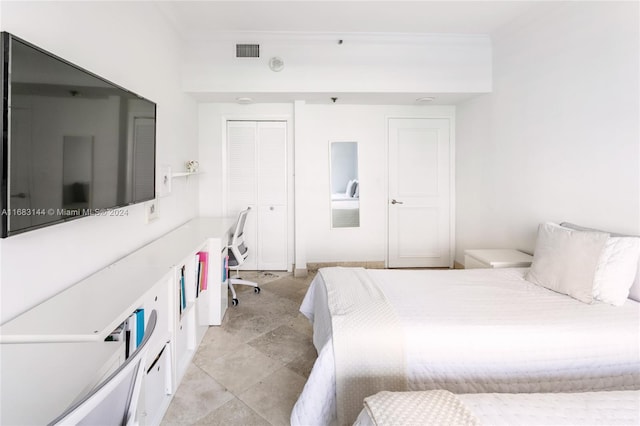 bedroom featuring ornamental molding and a closet