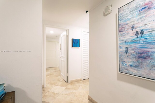 hall featuring light tile patterned flooring