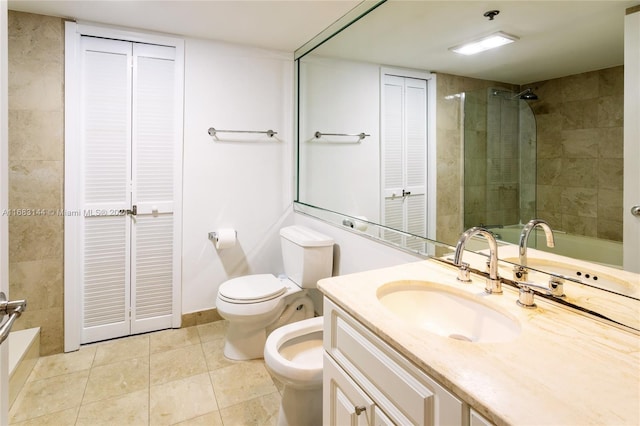 bathroom featuring vanity, a bidet, tile patterned floors, toilet, and a tile shower