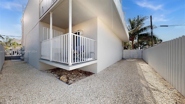 view of side of home featuring a balcony