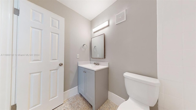 bathroom featuring toilet and vanity