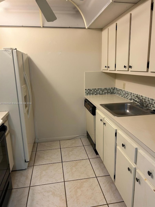 kitchen with backsplash, sink, light tile patterned floors, white cabinetry, and white appliances