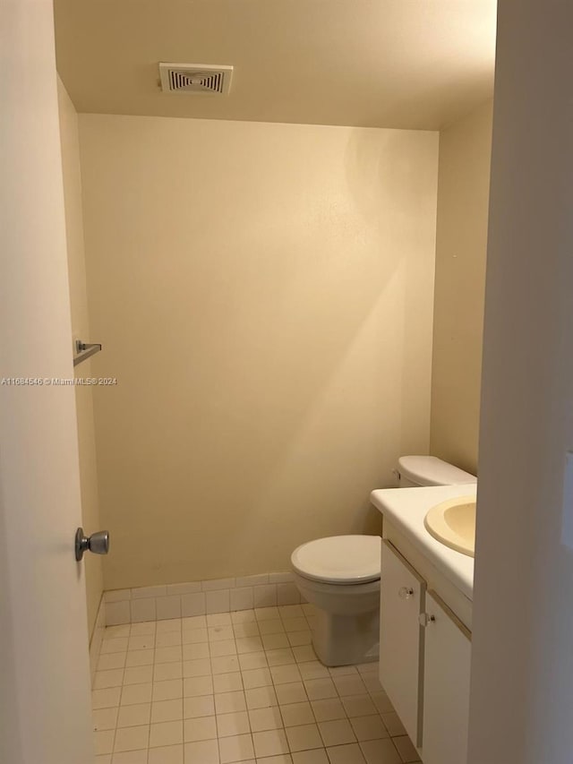 bathroom featuring vanity, toilet, and tile patterned flooring