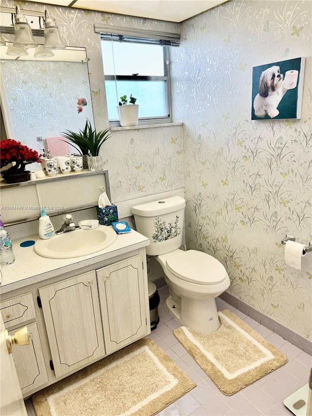 bathroom featuring vanity, toilet, and tile patterned flooring