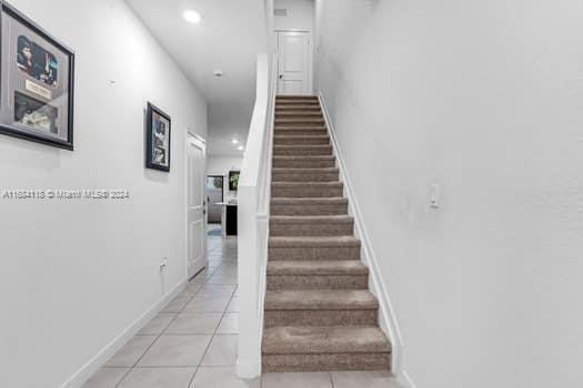 stairs with tile patterned flooring