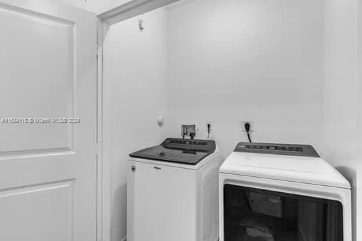 clothes washing area featuring independent washer and dryer