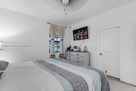 bedroom with light colored carpet and ceiling fan