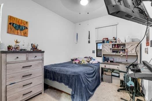 bedroom with light colored carpet and ceiling fan