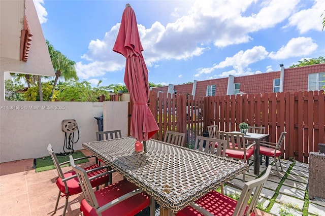 view of patio / terrace with outdoor dining space and fence