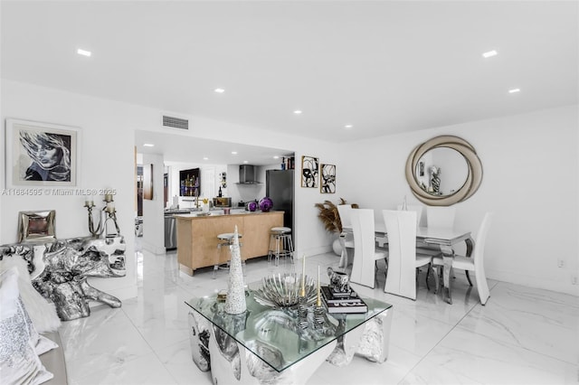 living area with visible vents, baseboards, recessed lighting, and marble finish floor