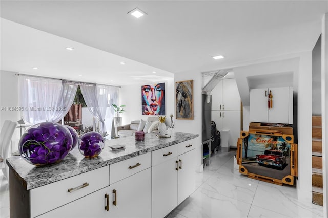 kitchen featuring white cabinetry, recessed lighting, marble finish floor, and light stone counters