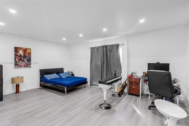 bedroom featuring recessed lighting and wood finished floors