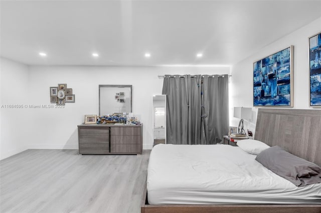bedroom featuring recessed lighting, baseboards, and wood finished floors