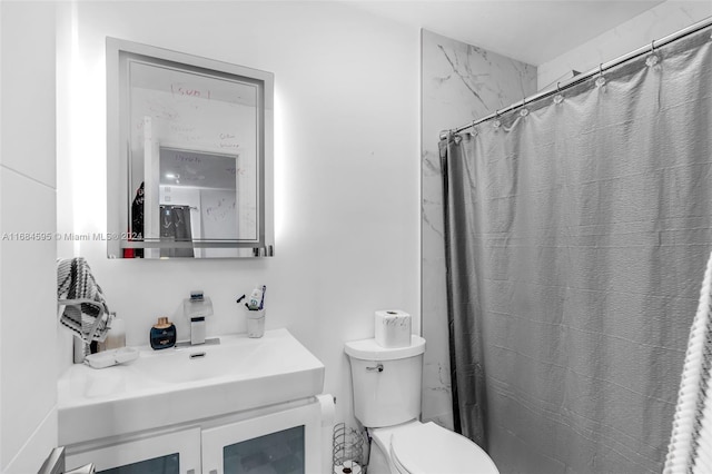 bathroom featuring toilet, vanity, and a shower with shower curtain