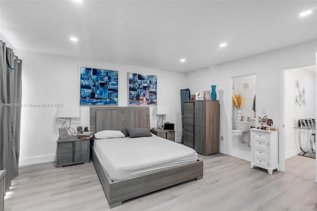bedroom with baseboards, recessed lighting, ensuite bath, and light wood-style floors
