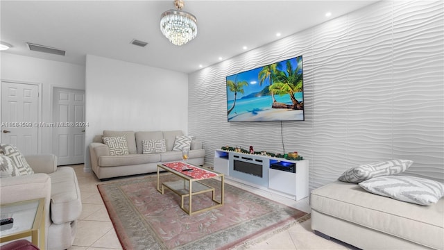 living room with a chandelier and light tile patterned floors