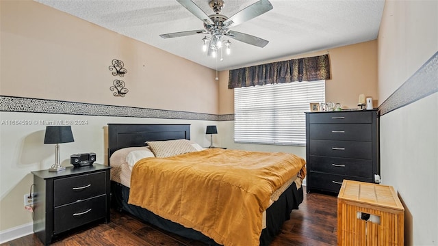 bedroom with a textured ceiling, dark hardwood / wood-style flooring, and ceiling fan