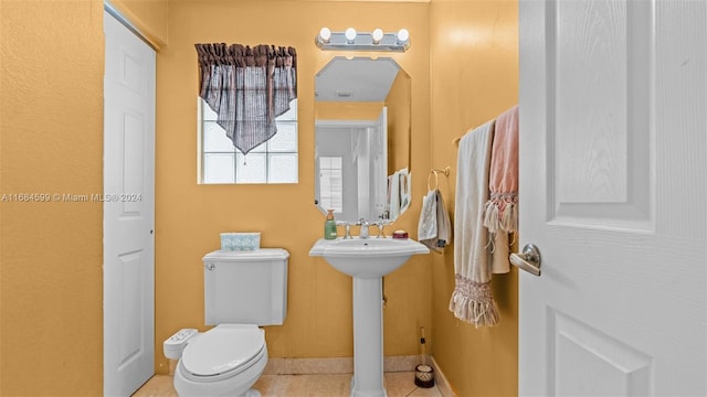 bathroom featuring tile patterned flooring, toilet, and sink