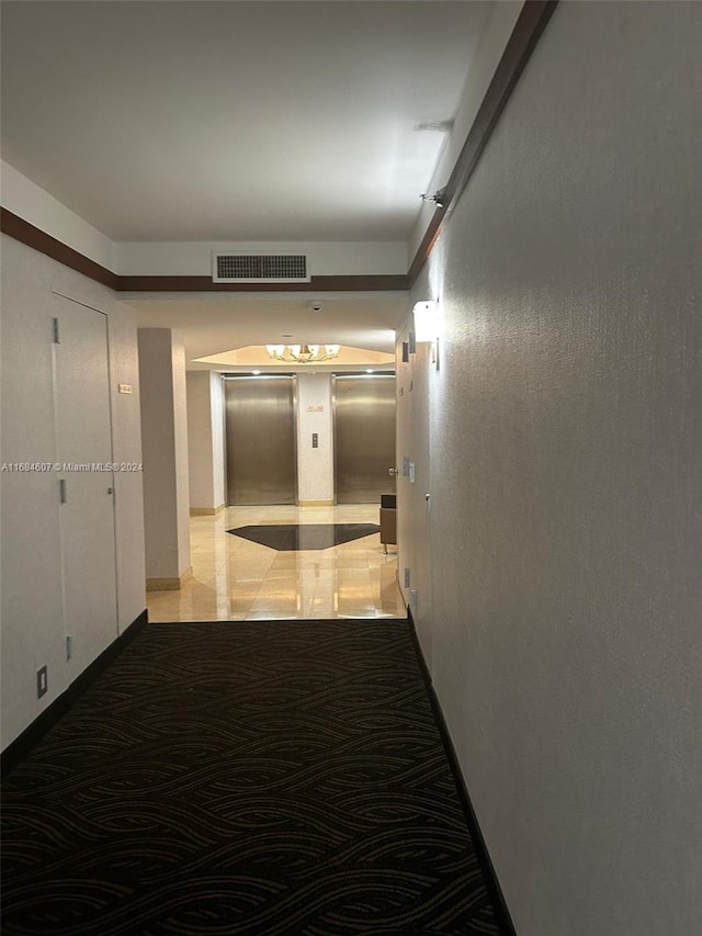 hall with light tile patterned floors