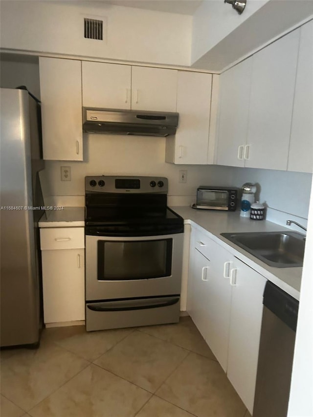 kitchen with white cabinetry, sink, light tile patterned floors, and appliances with stainless steel finishes