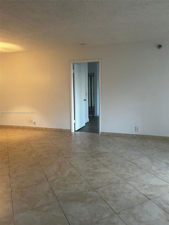 spare room with a textured ceiling