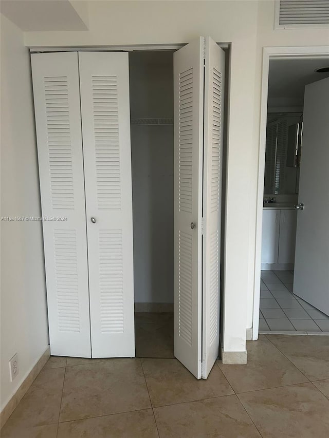 unfurnished bedroom featuring light tile patterned floors and sink