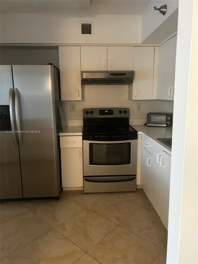 kitchen featuring light tile patterned floors, white cabinetry, and appliances with stainless steel finishes