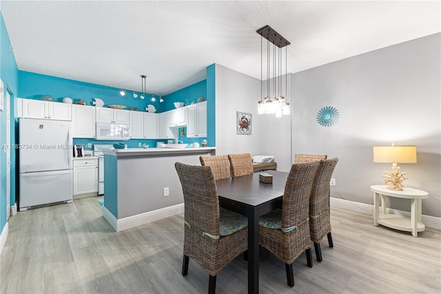 dining area with light hardwood / wood-style flooring