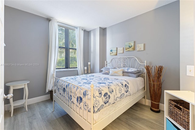 bedroom with hardwood / wood-style floors