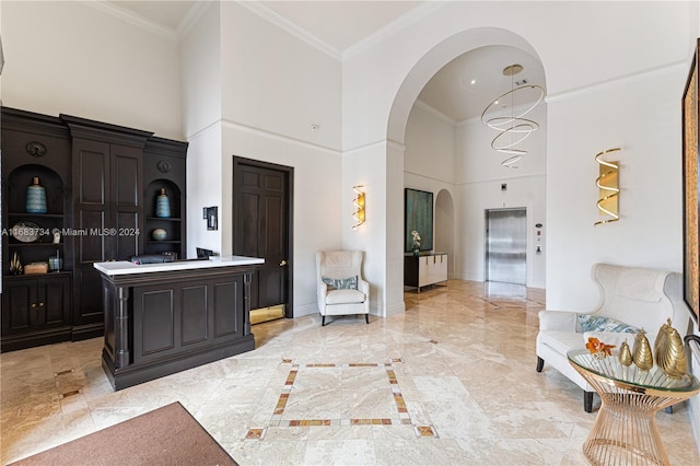 interior space with crown molding and a high ceiling