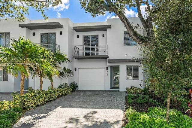 view of front of house featuring a balcony and a garage