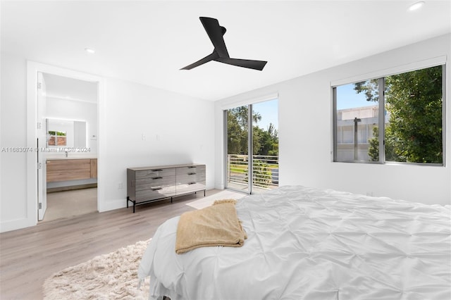 bedroom featuring ceiling fan, light wood-type flooring, ensuite bathroom, and access to outside