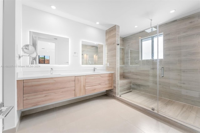 bathroom featuring a shower with door, vanity, and tile patterned flooring