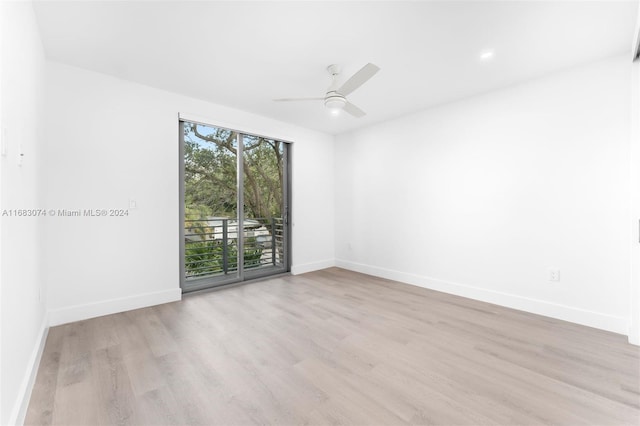 spare room featuring ceiling fan and light hardwood / wood-style flooring