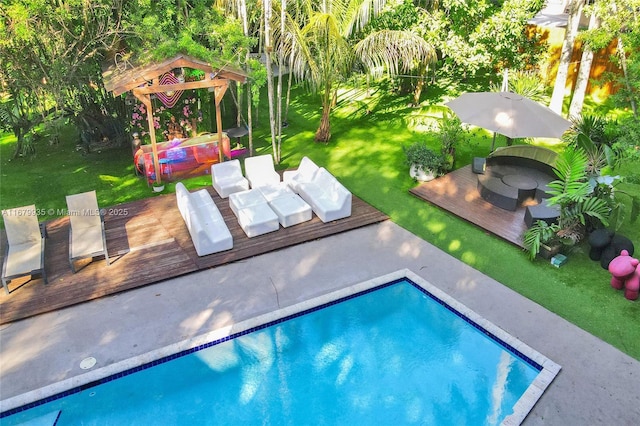 view of swimming pool with a deck and a lawn