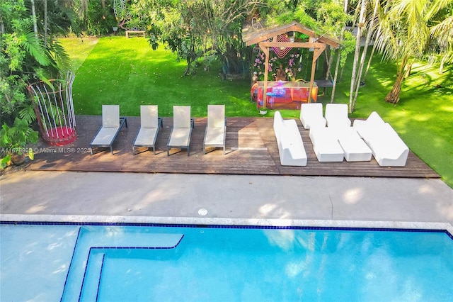 view of pool with a yard and a deck