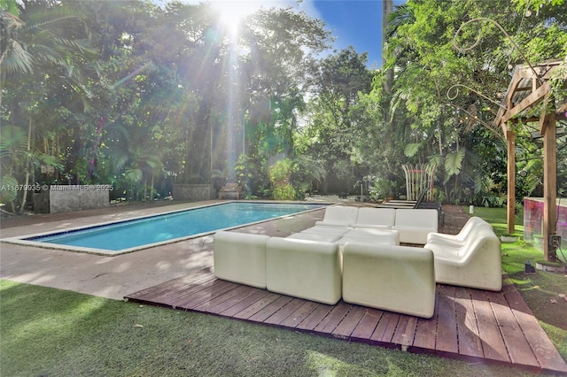 view of pool with outdoor lounge area and a patio