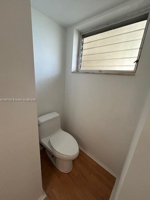 bathroom featuring toilet and hardwood / wood-style floors