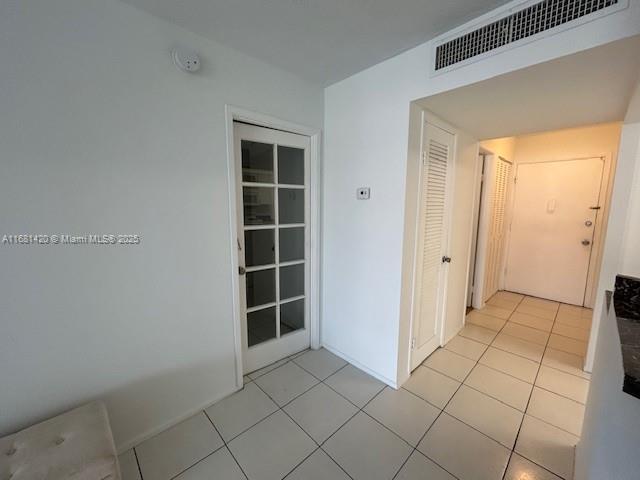 hallway featuring light tile patterned floors