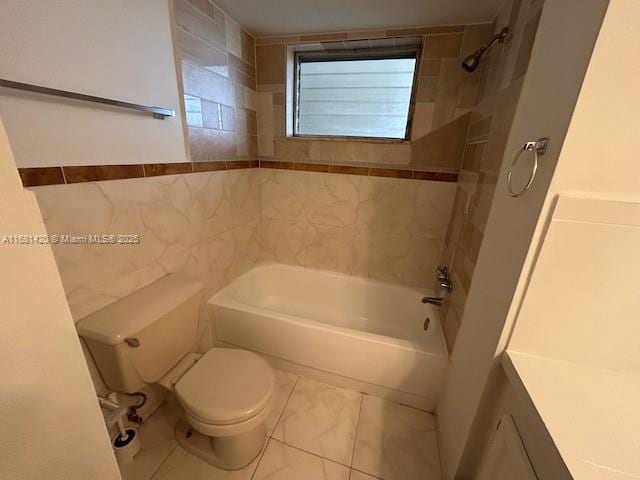 full bathroom featuring tile walls, toilet, vanity, and tiled shower / bath