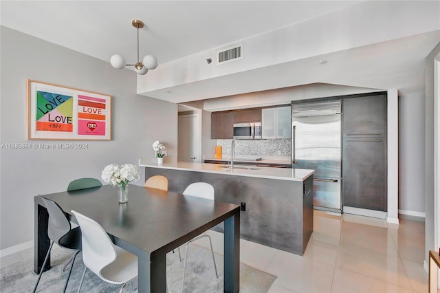 dining room with sink and light tile patterned floors