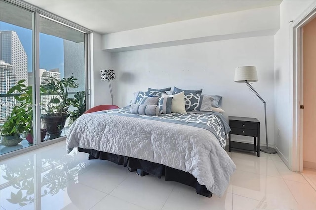 tiled bedroom with access to exterior and floor to ceiling windows