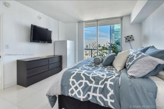 tiled bedroom featuring access to outside and a wall of windows