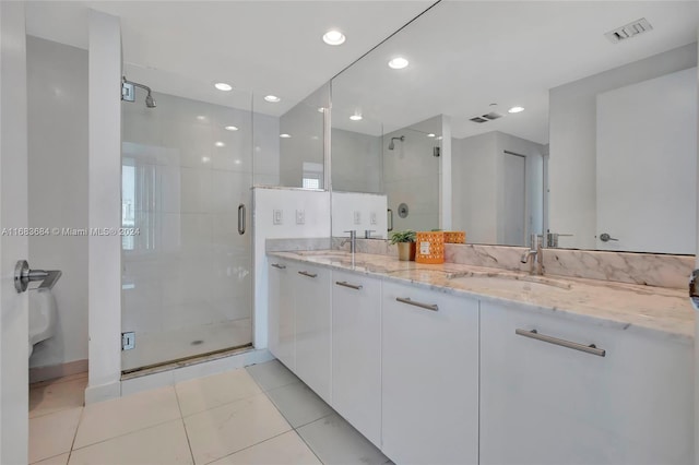 bathroom with vanity and a shower with shower door